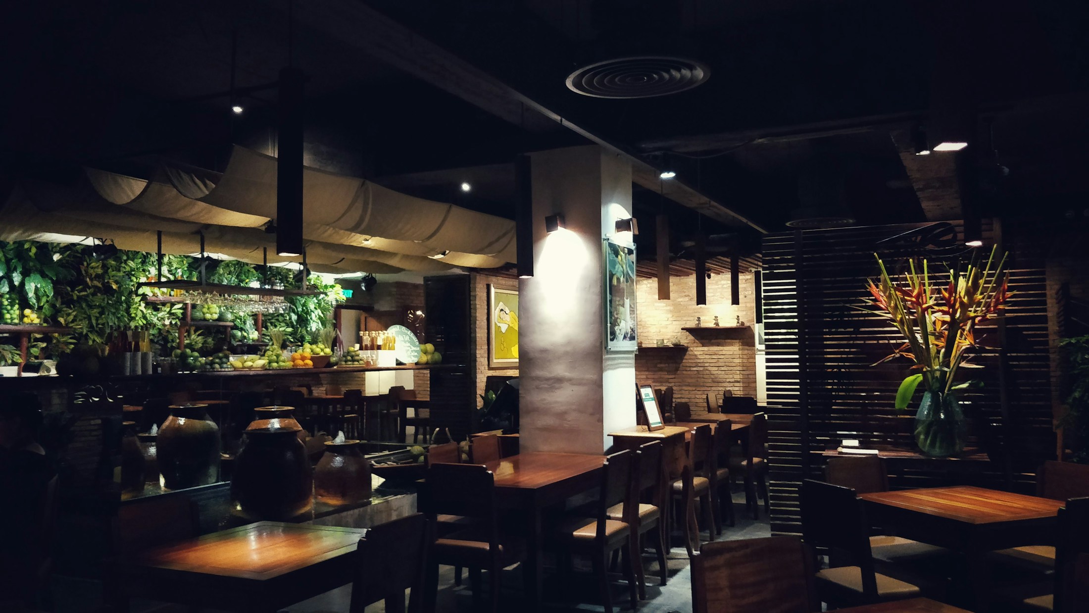 Warm dining room with wooden tables and low lighting